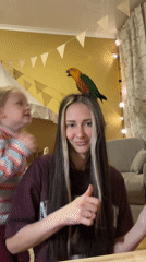 Woman dances with parrot on head in Khimki room