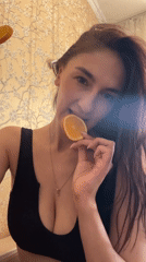Woman plays with orange slices indoors in Sochi