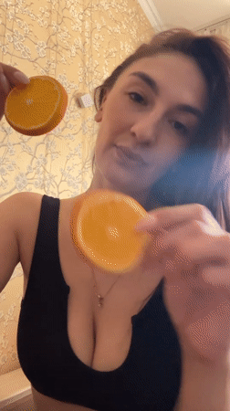 Woman plays with orange slices indoors in Sochi