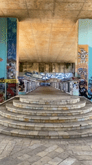 Riverside afternoon along Podgorica's graffiti-covered underpass corridor