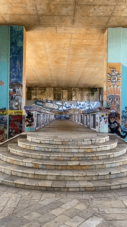 Riverside afternoon along Podgorica's graffiti-covered underpass corridor