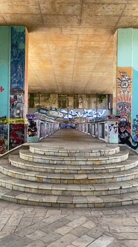 Riverside afternoon along Podgorica's graffiti-covered underpass corridor