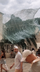 Budva's Old Town buzzes under a windswept art installation