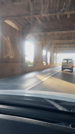 Driver passes under bridge in sunny Budva, Montenegro