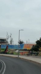 Vehicle records colorful street mural in Arica, Chile