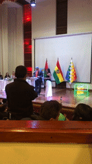 Formal ceremony with traditional-dressed speakers held in La Paz auditorium