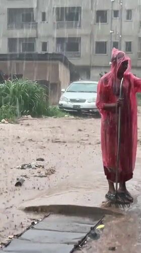 Heavy rains flood Nkpor streets, resident with broom observed