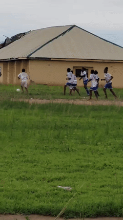 Children play soccer and dance on field in Zaga Nigeria