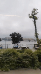 Train passenger films Istanbul waterfront with boats and cityscape
