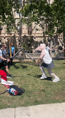 Young adults stage playful mock battle in Barcelona park