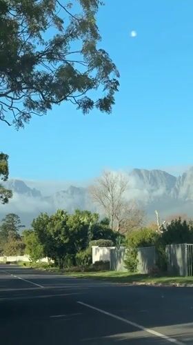 Driver travels through Somerset West residential streets on sunny afternoon