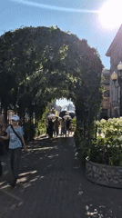 Yandex delivery robots roam a sunny Moscow neighborhood with a Ducati nearby