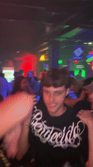 Late-night crowd dances at São Paulo nightclub under colorful lights