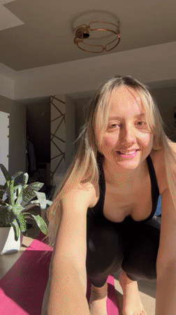 Woman takes mirror selfies on yoga mat in Latvia