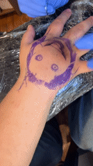 Tattoo artists work on clients at Buenos Aires studio