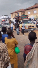 Urban street life: entertainers, shoe polisher, market activity observed