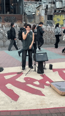 Street musician busks with ukulele on Seoul sidewalk