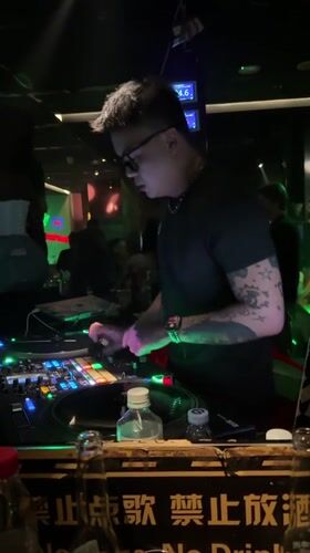 DJ performs for dancing crowd at Liangjiang nightclub
