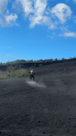 Motocross rider navigates volcanic terrain near Kintamani, Indonesia