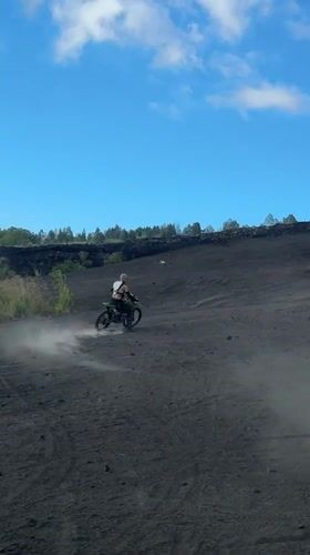 Motocross rider navigates volcanic terrain near Kintamani, Indonesia