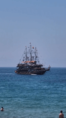 Pirate ship sails past Alanya beaches on clear morning