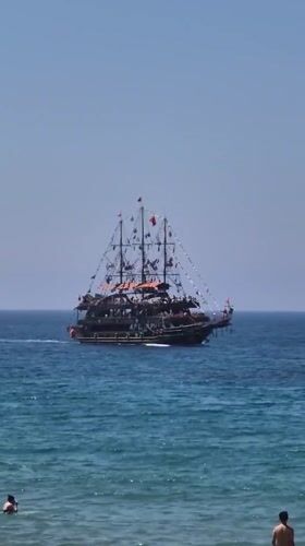 Pirate ship sails past Alanya beaches on clear morning