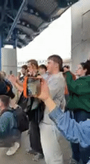 Emotional flower-filled gathering at Kyiv train station draws crowds