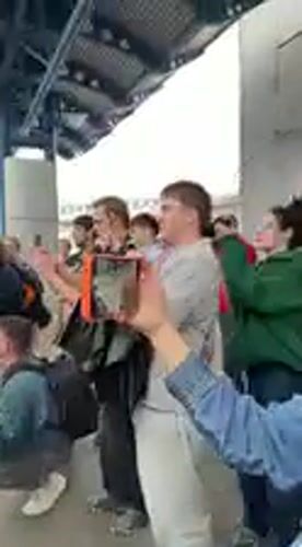 Emotional flower-filled gathering at Kyiv train station draws crowds