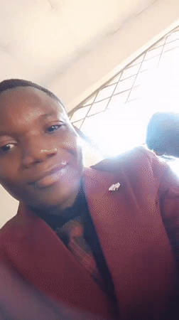Indoor gathering documented in Madalla, Nigeria with selfies and seating
