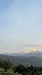 Green hills and snow-capped peaks captured near Rodès, France