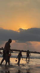 Golden hour on the Netanya coast, clouds and calm water