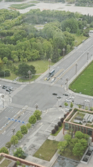 Early morning traffic flows through green city intersection