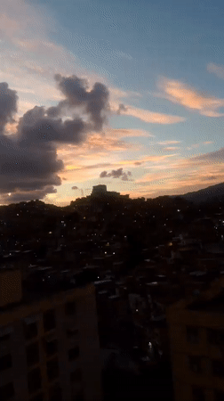 Dramatic sunset illuminates Caracas cityscape with colorful twilight skies