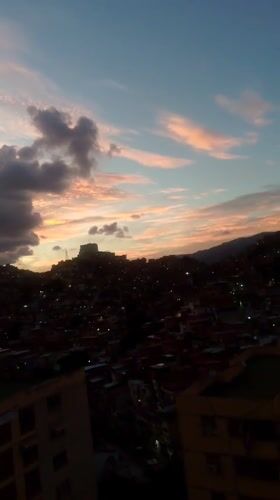 Dramatic sunset illuminates Caracas cityscape with colorful twilight skies