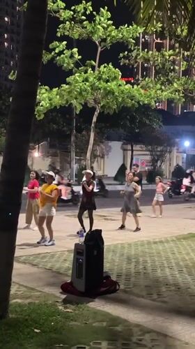 Evening exercise groups and beachgoers active in Nha Trang