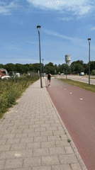 Morning jogger spotted near Rijswijk water tower on sunny day