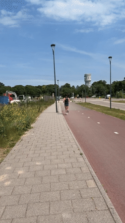Morning jogger spotted near Rijswijk water tower on sunny day