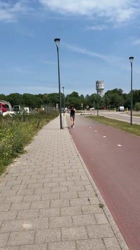 Morning jogger spotted near Rijswijk water tower on sunny day