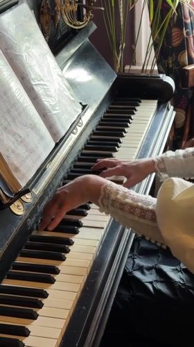 Woman plays vintage piano in historical Kolomna setting