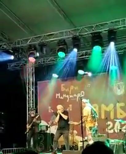 Live outdoor concert with colorful stage lighting in Yambol