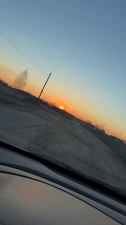 Dashcam captures sunset drive on rural road in Russia