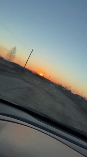 Dashcam captures sunset drive on rural road in Russia