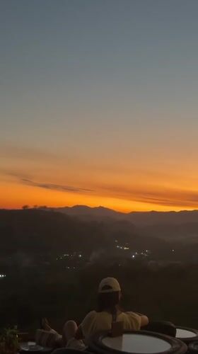 Sunset gathering at a hillside café overlooking Kuta's mountain valley