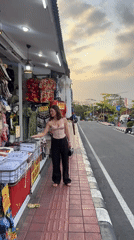 Street stalls, a temple gate, and a cat in Kediri