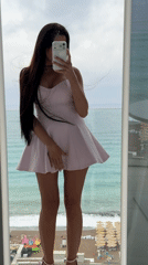 Woman Takes Mirror Selfies on Coastal Balcony in Montenegro