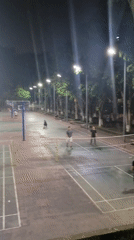 Badminton players active on wet outdoor courts in Shapingba