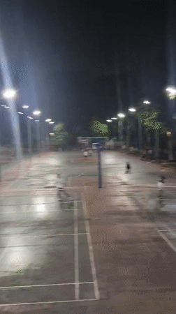 Badminton players active on wet outdoor courts in Shapingba