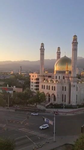Golden-domed mosque in Almaty seen from above at sunrise