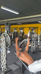 Man performs bench press workout at Paris gym