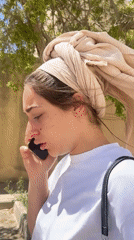 Woman makes phone call outdoors in Mitzpe Ramon